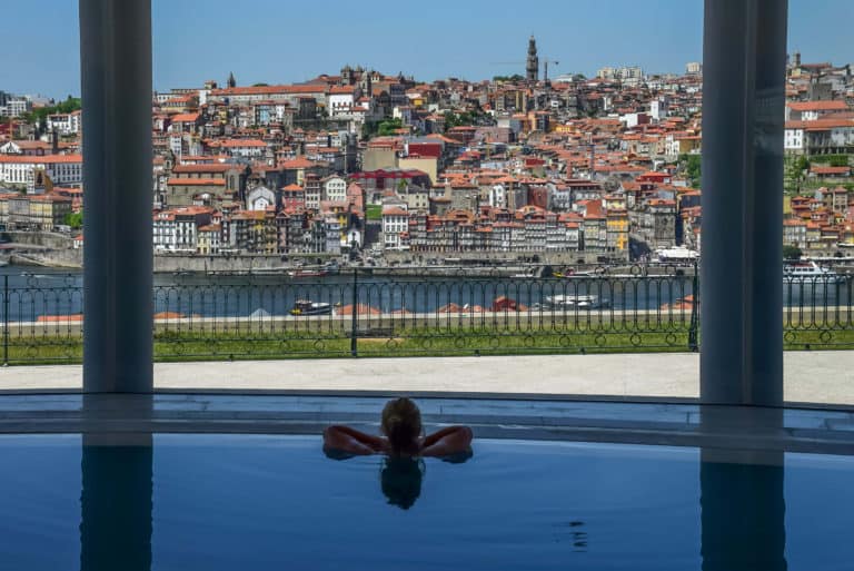 Person in pool with view of Porto, Portugal