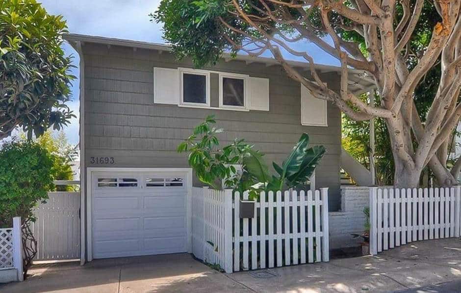 Small grey house and picket fence airbnb in Laguna Beach, California