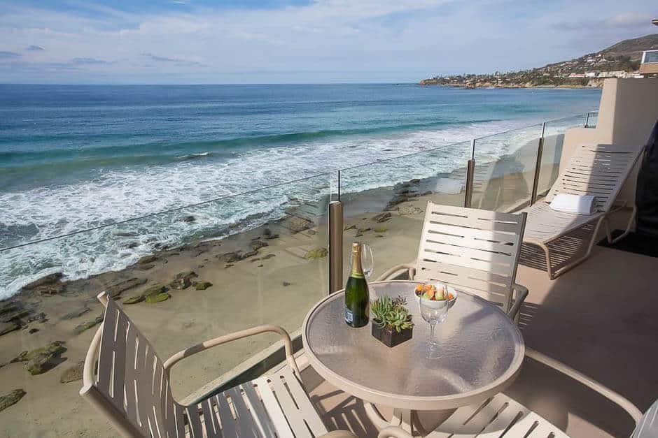 Balcony with table and chairs overlooking the beach and ocean