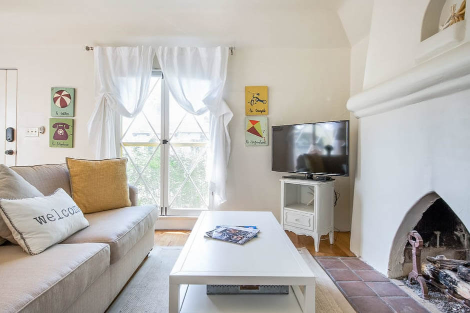 Bright living room with Spanish style fireplace in California USA
