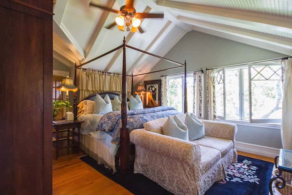 Four-poster bed in high ceiling bedroom