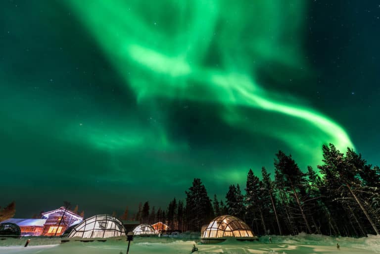 Finland aurora borealis over igloos and cabins in the happiest country