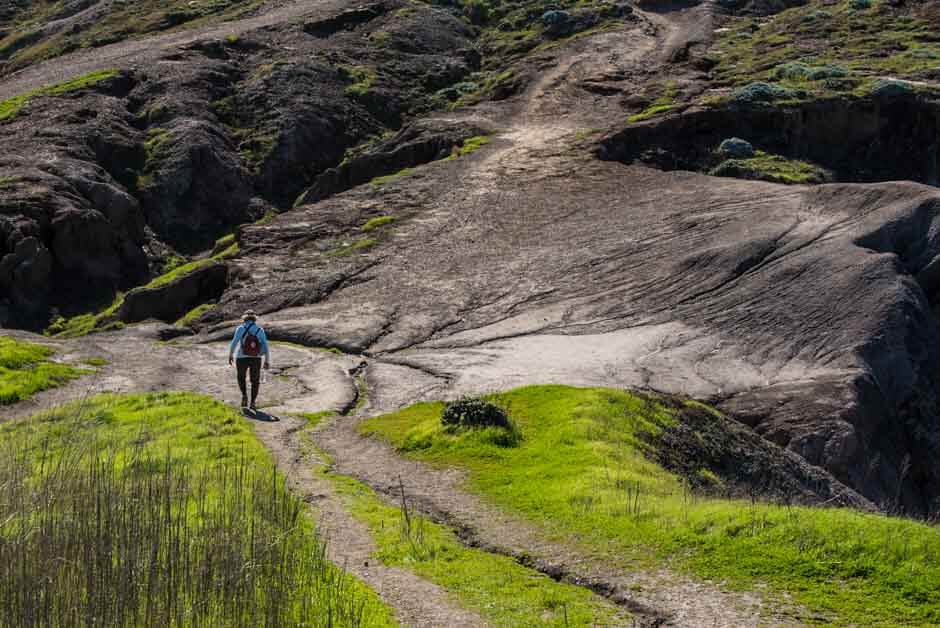 A person hikes up an exposed rockface in Channel Islands National Park, California