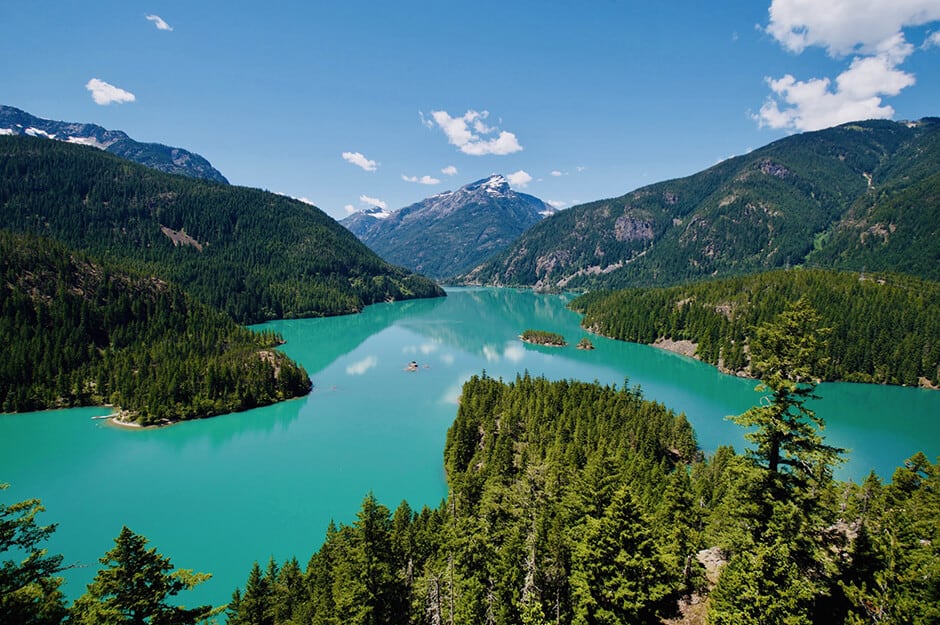 Beautiful views of a lake surrounded by mountains in North Cascades National Park, Washington, one of the most scenic west coast national parks.