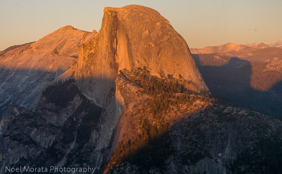 Stunning Half Dome mountain peak glows in the sunset in Yosemite National Park, California