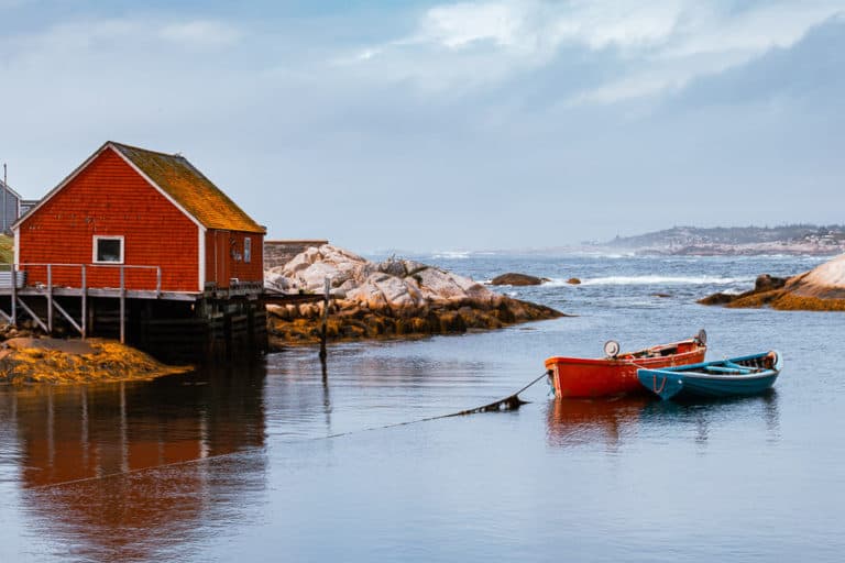 Red Fishing stage and boats in a harbour in Nova Scotia